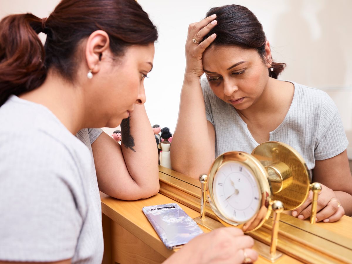Woman exhausted, sitting with her thoughts, struggling with fatigue and brain fog